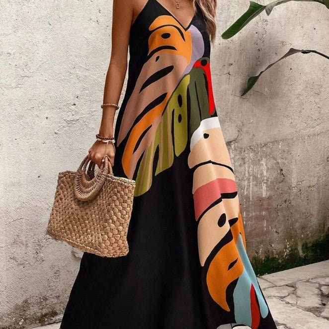 Women's tropical sleeveless maxi dress with vibrant leaf print, perfect for summer vacations & beach resort wear.