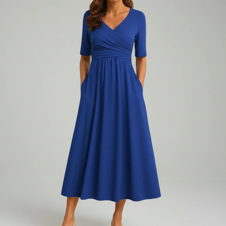 Stylish women's midi dress with an A-line silhouette, V-neck, and essential pockets for everyday comfort.