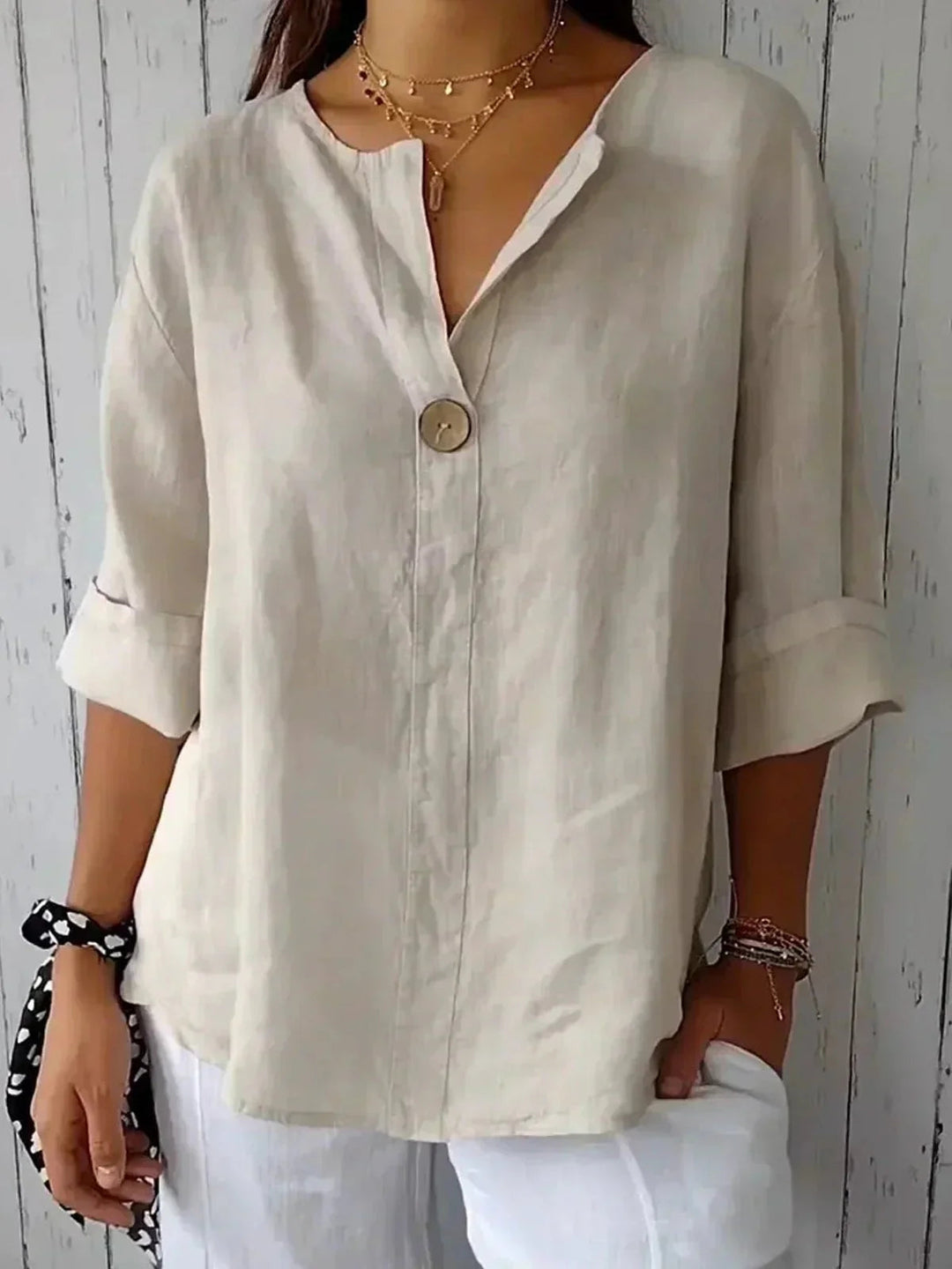 Women's V-neck blouse with roll-tab sleeves & button-down front. Perfect for casual or office wear.