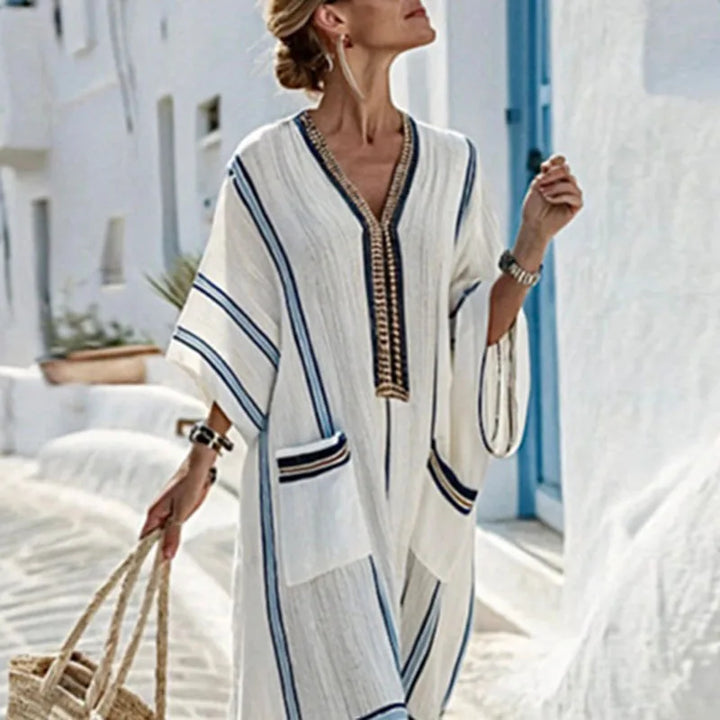 Flowy women's kimono maxi dress with V-neck, designed for beach vacations. Features comfortable relaxed fit & pockets.