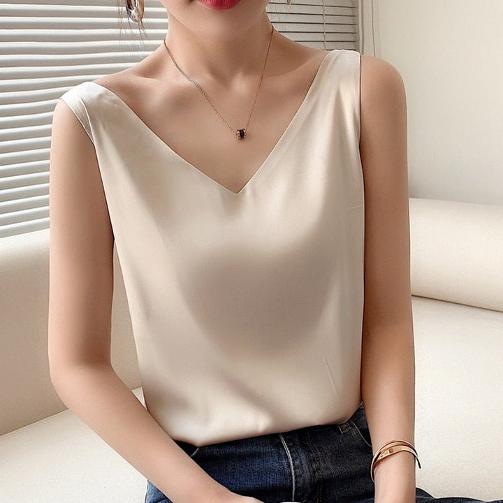 Modern V-neck sleeveless blouse, a loose fit women's tank top ideal as a layering piece for chic outfits.