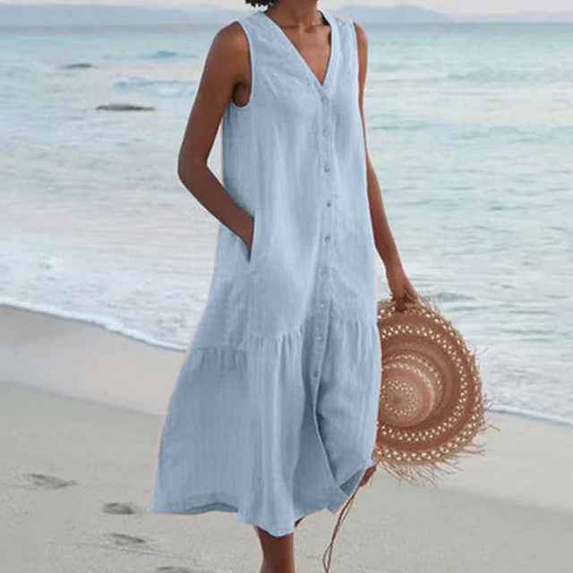 Close-up of the delicate button-front detail and flowing ruffle hem on a women's midi dress.