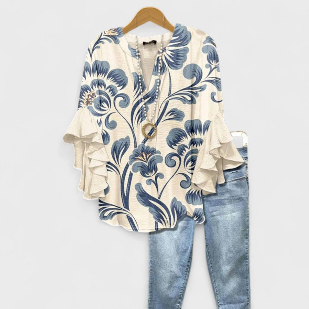 Women's vintage floral V-neck blouse with ruffle sleeves. Elegant spring/summer fashion.