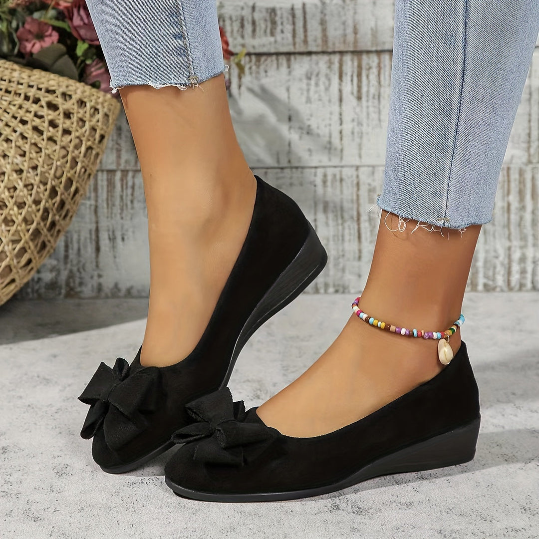Elegant ladies slip-on wedge flats, featuring a classic round toe & cute bow detail, perfect for office.