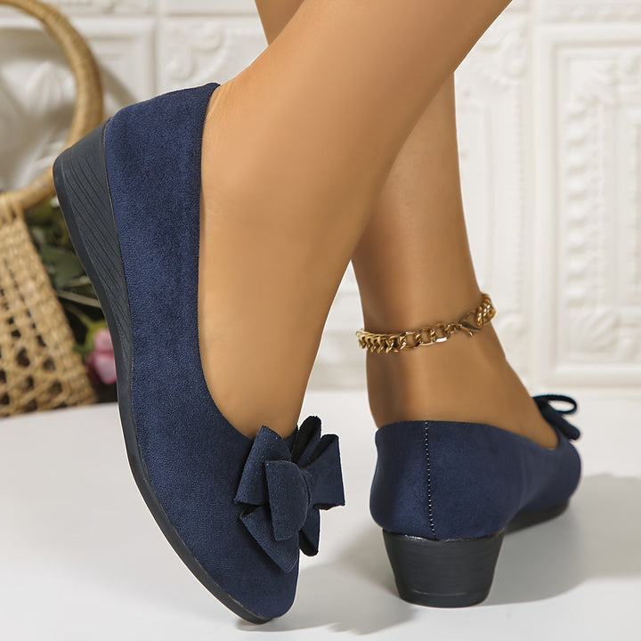 Versatile women's slip-on wedge flats with a bow and round toe, ideal for casual and office wear.