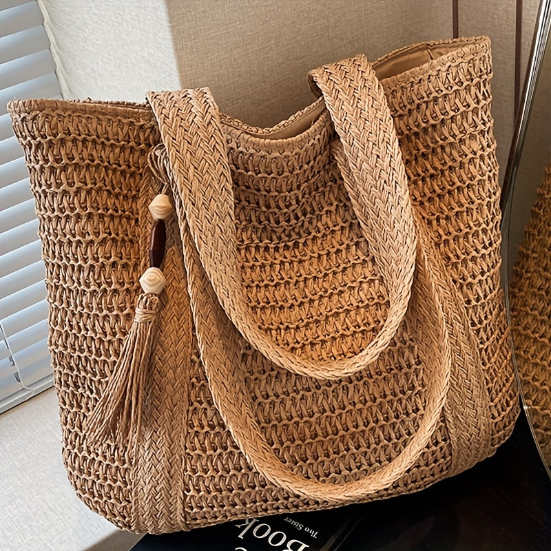 Women's woven straw tote bag with stylish fringe tassel, perfect for summer & beach outings.
