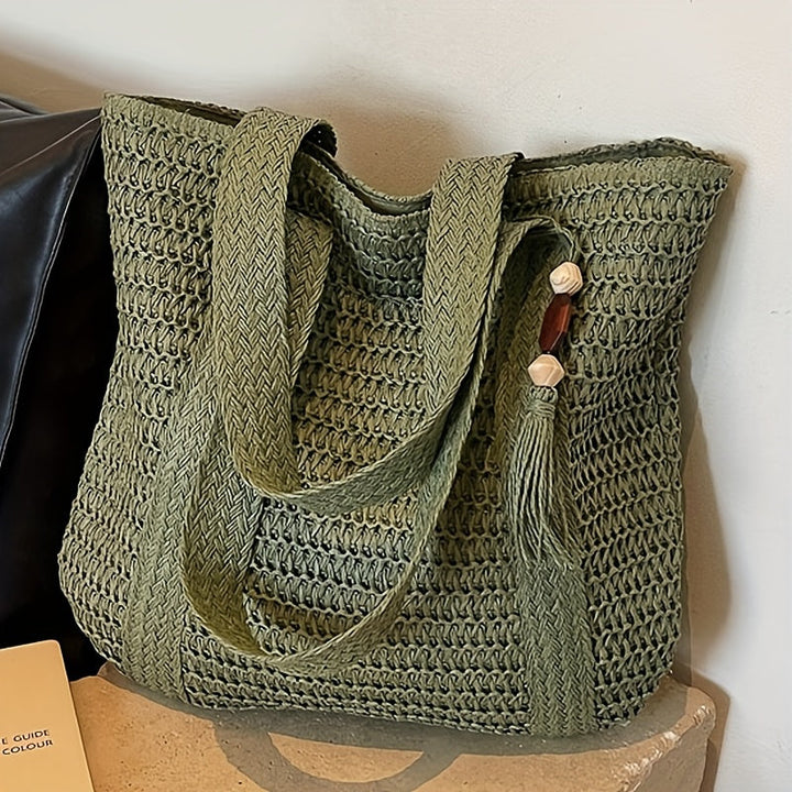 Boho-chic women's natural fiber straw shoulder bag with fringe, ideal as a summer purse.