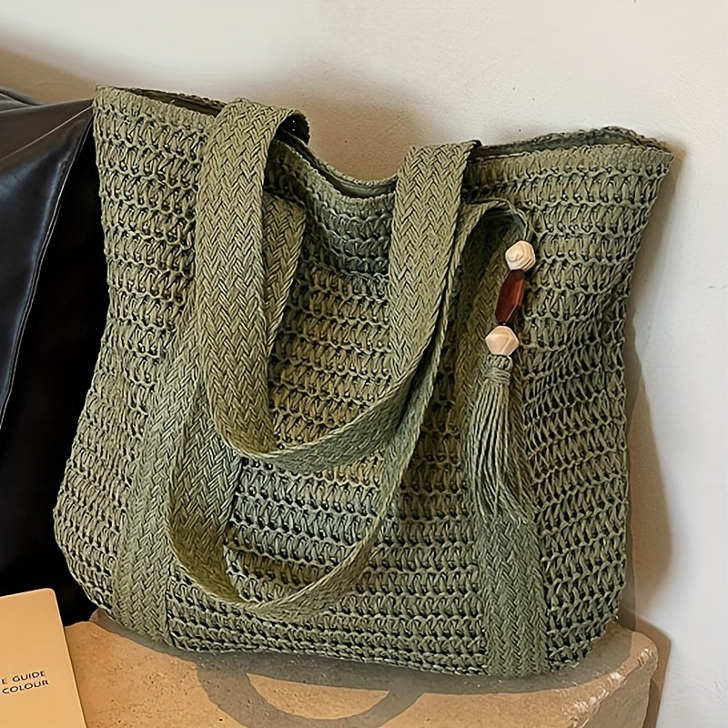 Lightweight woven straw beach tote with a charming fringe tassel, excellent for summer vacations.