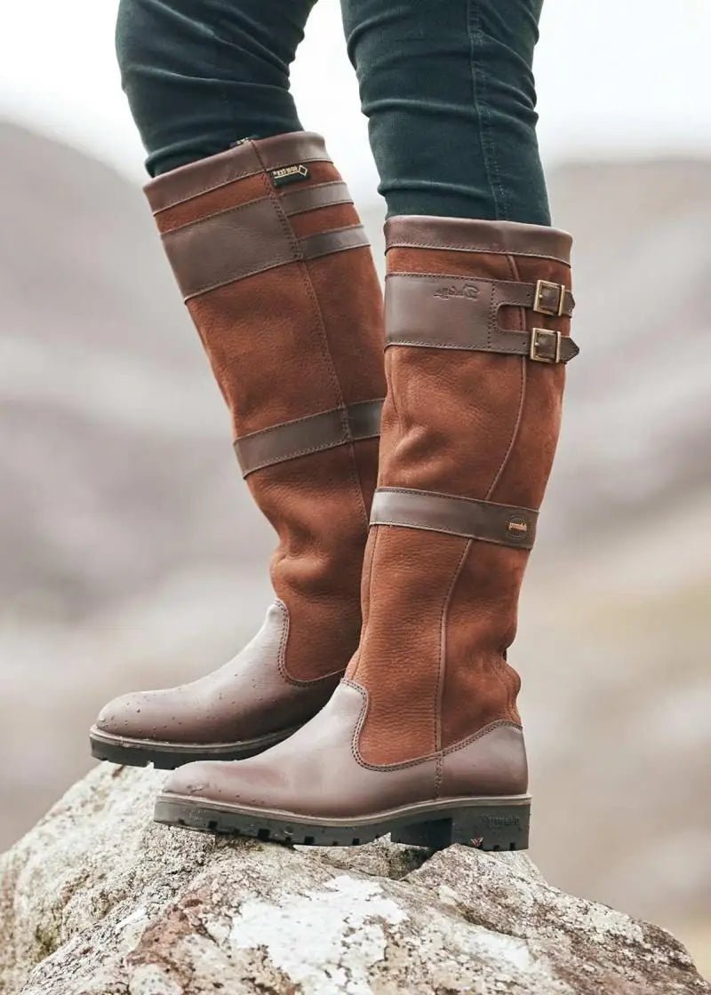 Stylish women's knee-high pull-on waterproof boots, perfect for comfort & protection in all weather conditions.