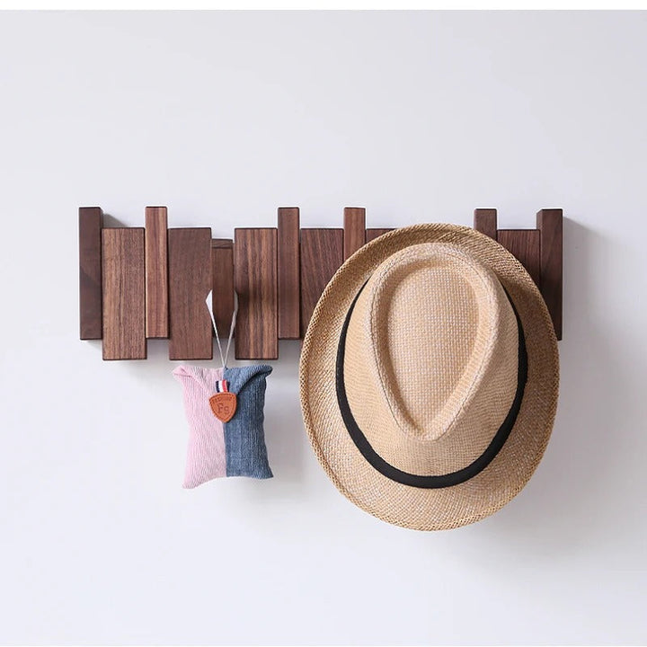 Stylish wood finish wall mount hook rack featuring unique piano key design. Space-saving entryway organization.