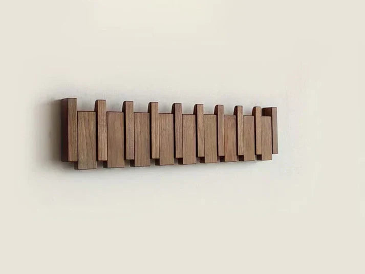 Entryway organization with this stylish piano key wall mount coat rack. Modern wood finish home decor.
